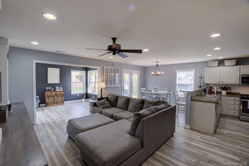 87 Yadkin Road Fletcher, NC 28732 - Photo 11 of 34 a living room with furniture and wooden floor