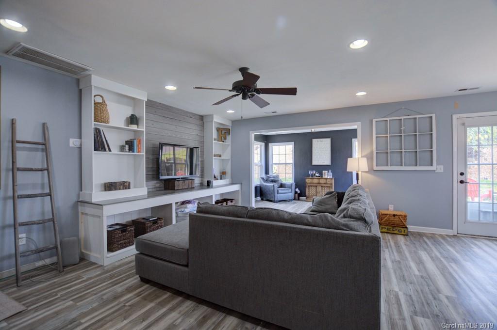 87 Yadkin Road Fletcher, NC 28732 - Photo 14 of 34 a living room with furniture kitchen view and a wooden floor