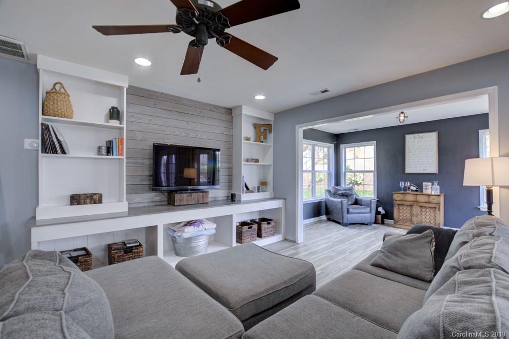 87 Yadkin Road Fletcher, NC 28732 - Photo 15 of 34 a living room with furniture kitchen view and a fireplace