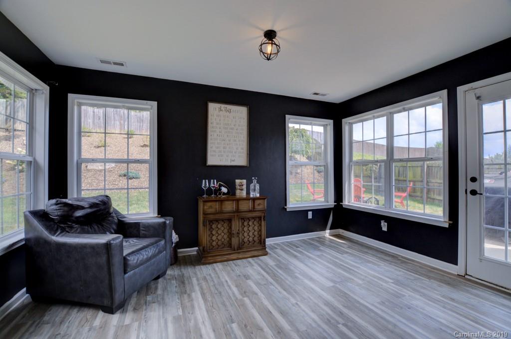 87 Yadkin Road Fletcher, NC 28732 - Photo 17 of 34 a living room with furniture and a large window