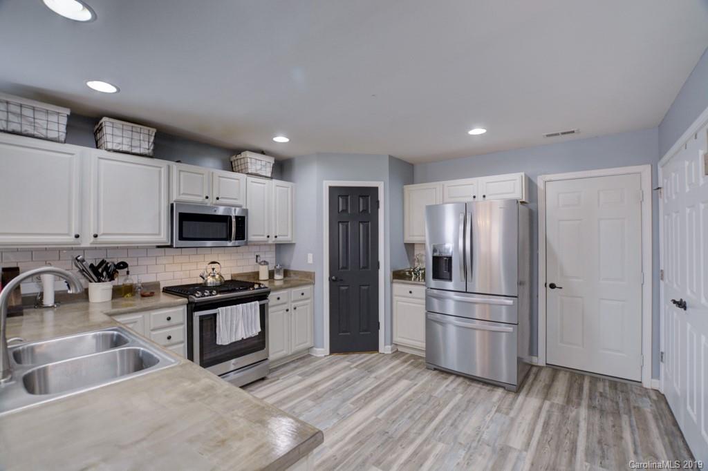 87 Yadkin Road Fletcher, NC 28732 - Photo 20 of 34 a kitchen with stainless steel appliances granite countertop a refrigerator and a sink