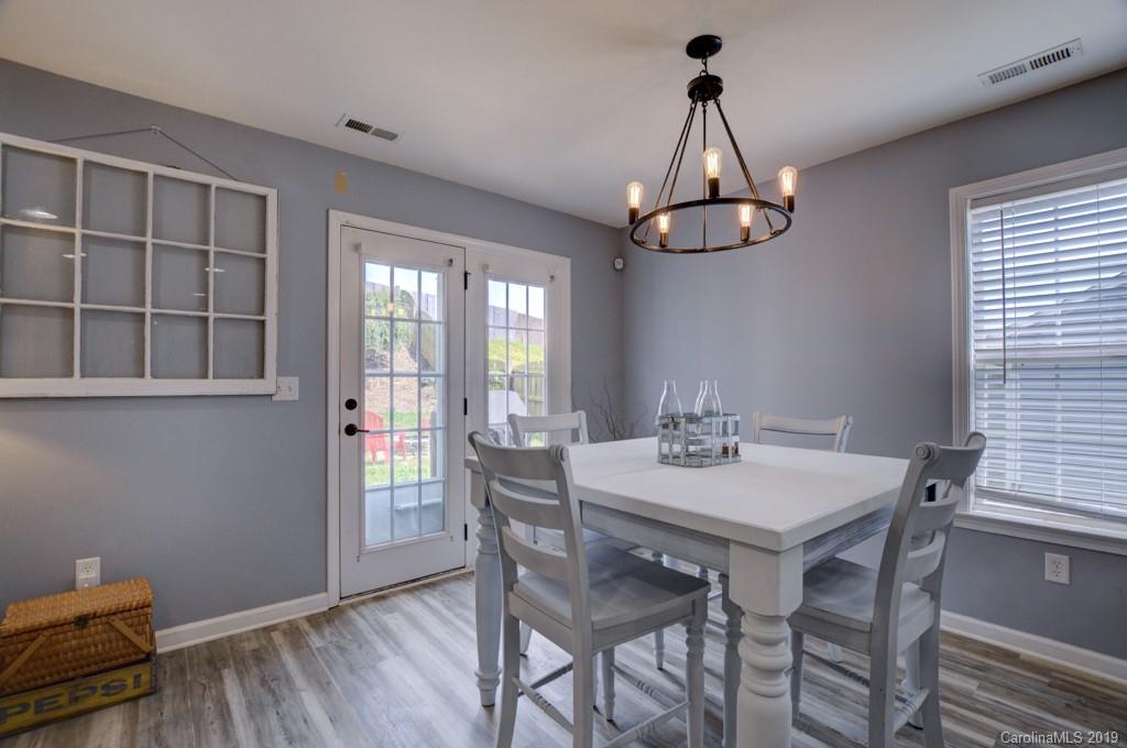 87 Yadkin Road Fletcher, NC 28732 - Photo 21 of 34 a view of a dining room with furniture window and wooden floor