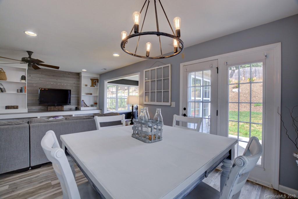 87 Yadkin Road Fletcher, NC 28732 - Photo 22 of 34 a view of a dining room with furniture window and wooden floor