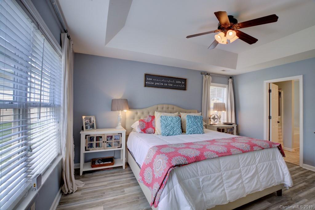 87 Yadkin Road Fletcher, NC 28732 - Photo 23 of 34 a bedroom with a bed and a chandelier