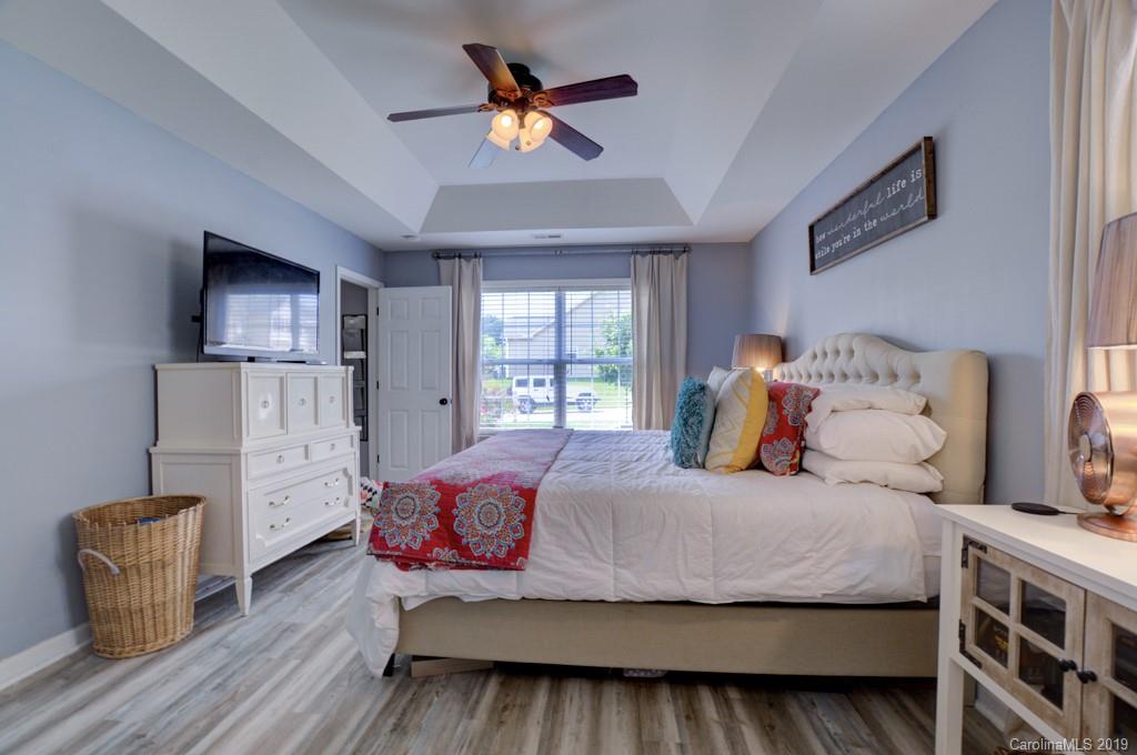 87 Yadkin Road Fletcher, NC 28732 - Photo 24 of 34 a bedroom with a bed and a couch