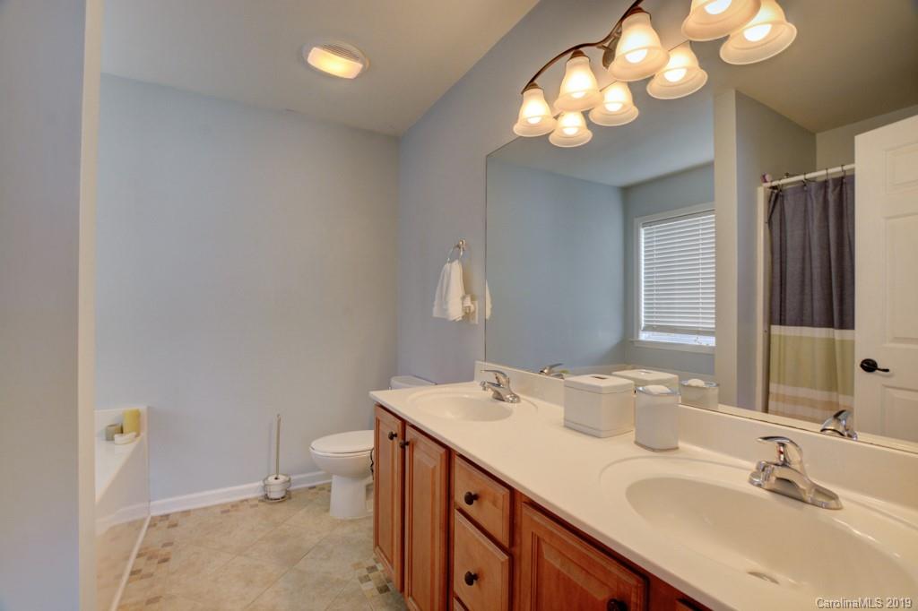 87 Yadkin Road Fletcher, NC 28732 - Photo 25 of 34 a bathroom with a sink a toilet and a mirror