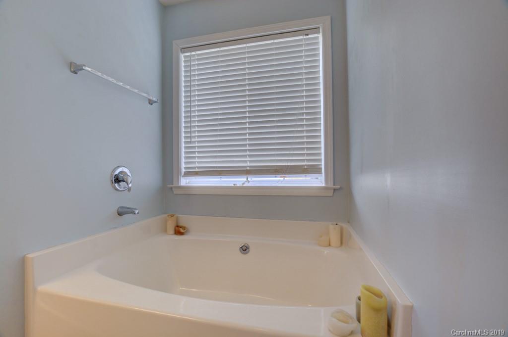 87 Yadkin Road Fletcher, NC 28732 - Photo 26 of 34 a white bath tub sitting next to a window