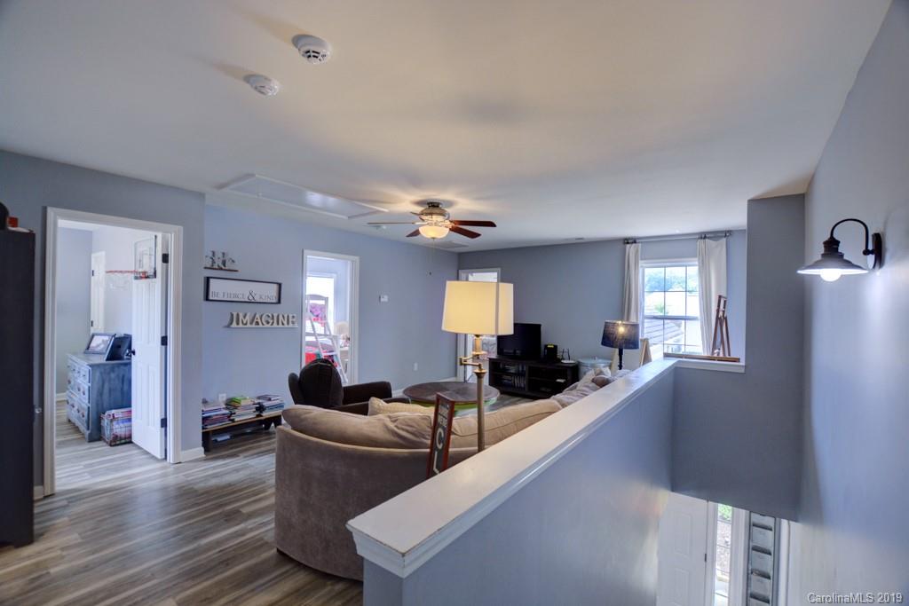 87 Yadkin Road Fletcher, NC 28732 - Photo 27 of 34 a living room with furniture and wooden floor