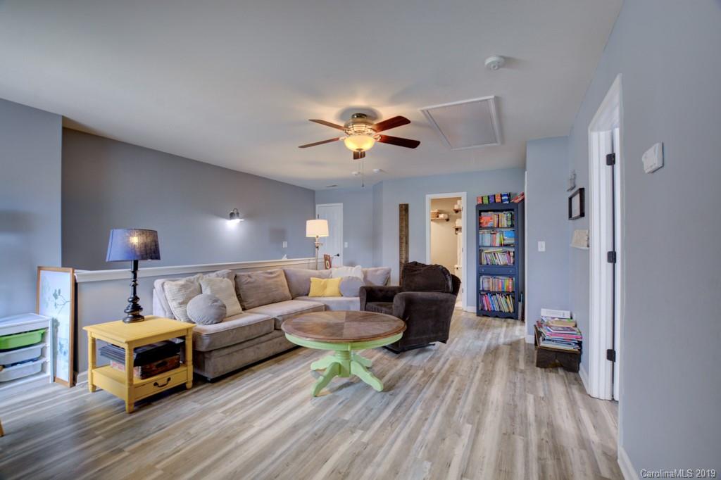 87 Yadkin Road Fletcher, NC 28732 - Photo 29 of 34 a living room with furniture and a wooden floor