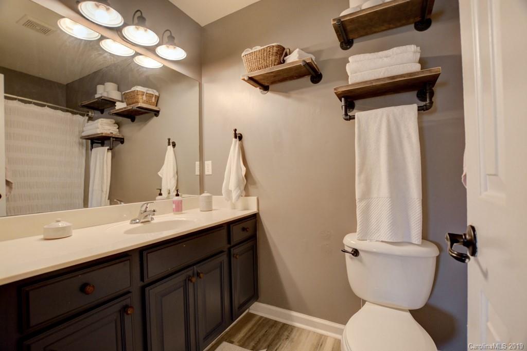 87 Yadkin Road Fletcher, NC 28732 - Photo 33 of 34 a bathroom with a toilet sink and mirror