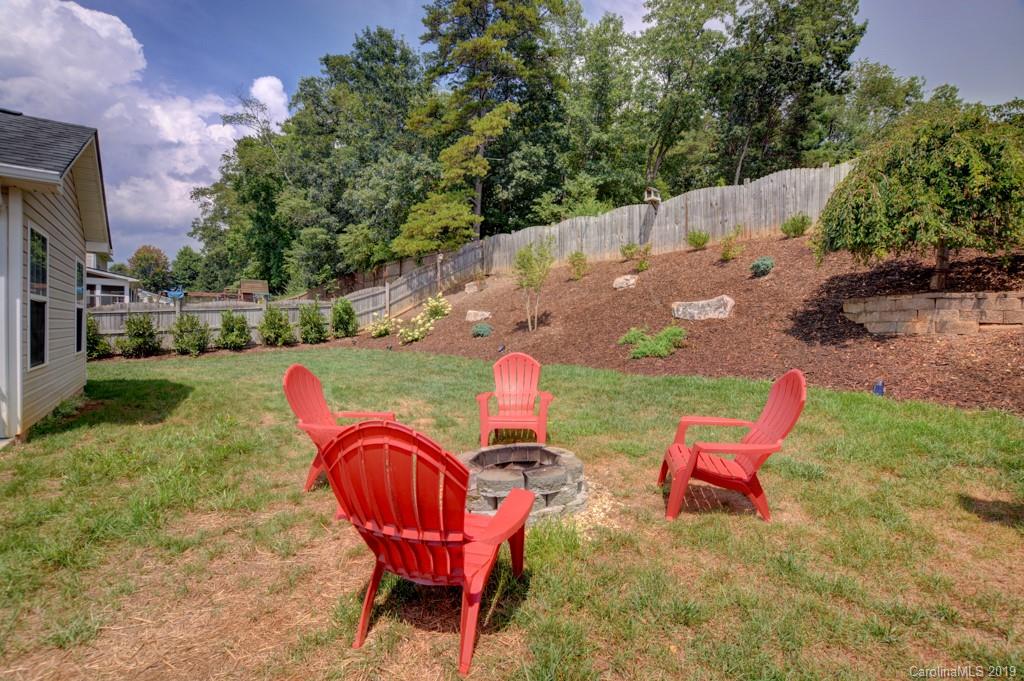 87 Yadkin Road Fletcher, NC 28732 - Photo 6 of 34 a backyard of a house with table and chairs