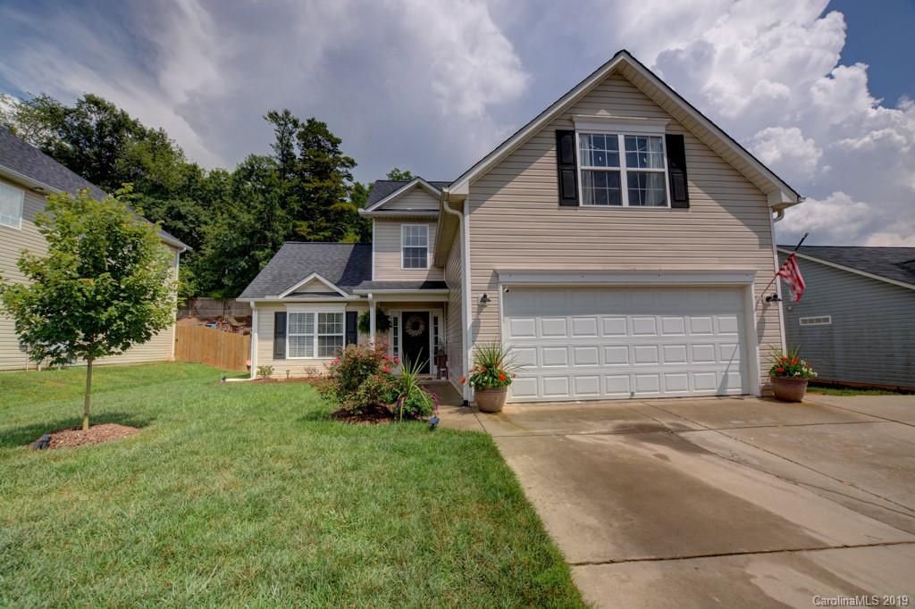 87 Yadkin Road Fletcher, NC 28732 - Photo 7 of 34 a front view of a house with a yard and garage
