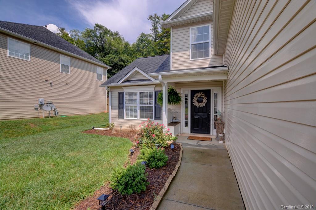 87 Yadkin Road Fletcher, NC 28732 - Photo 8 of 34 a front view of a house with garden