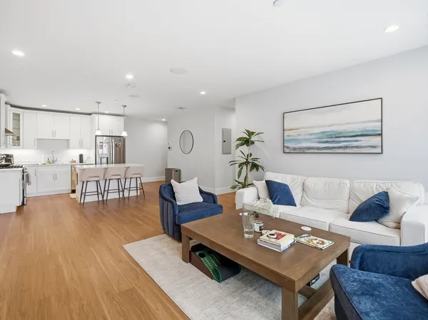 a living room with furniture and wooden floor