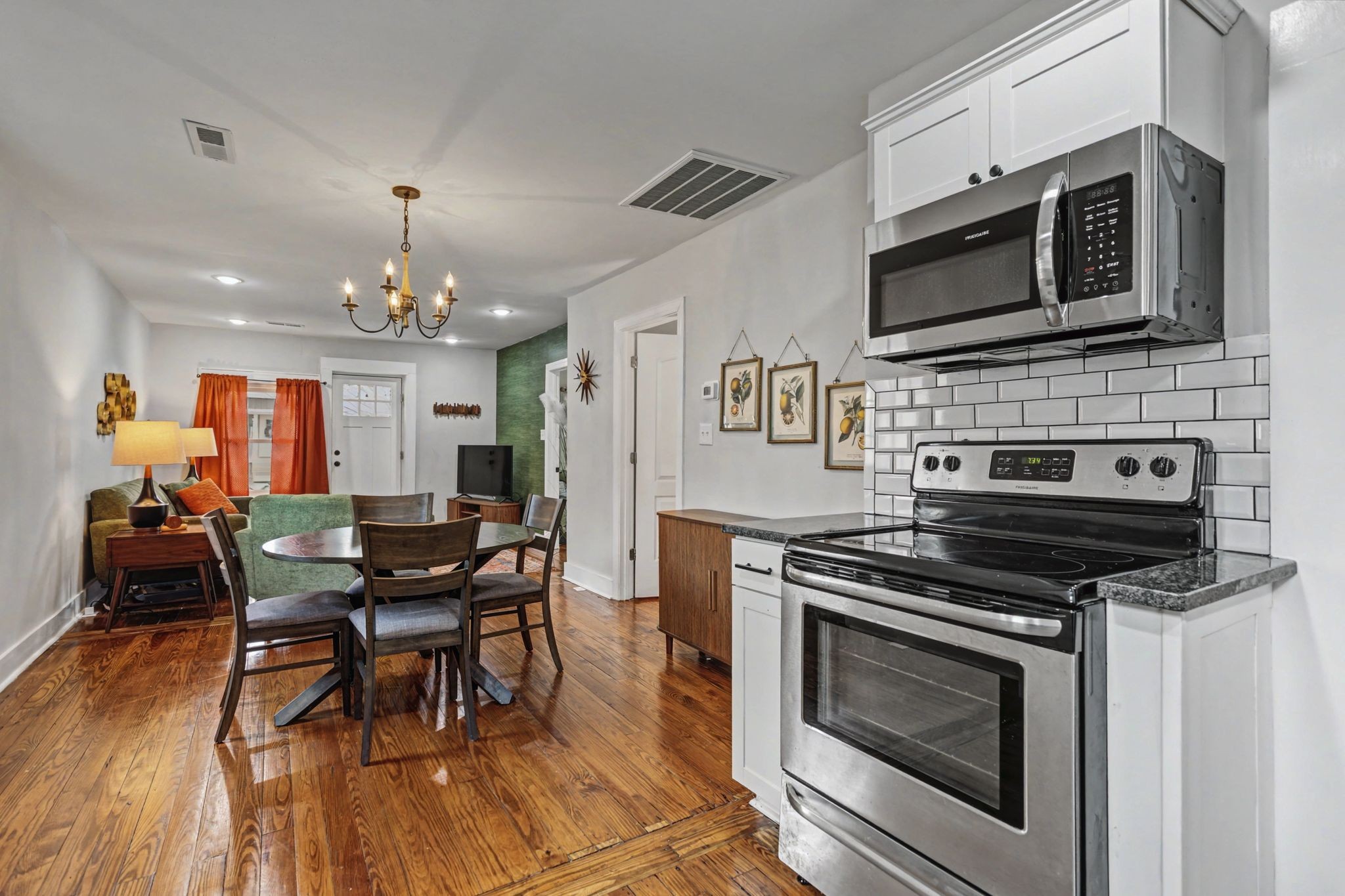 511 Florida Avenue Mount Pleasant, TN 38474 - Photo 12 of 28 a kitchen with stainless steel appliances a stove a microwave and white cabinets