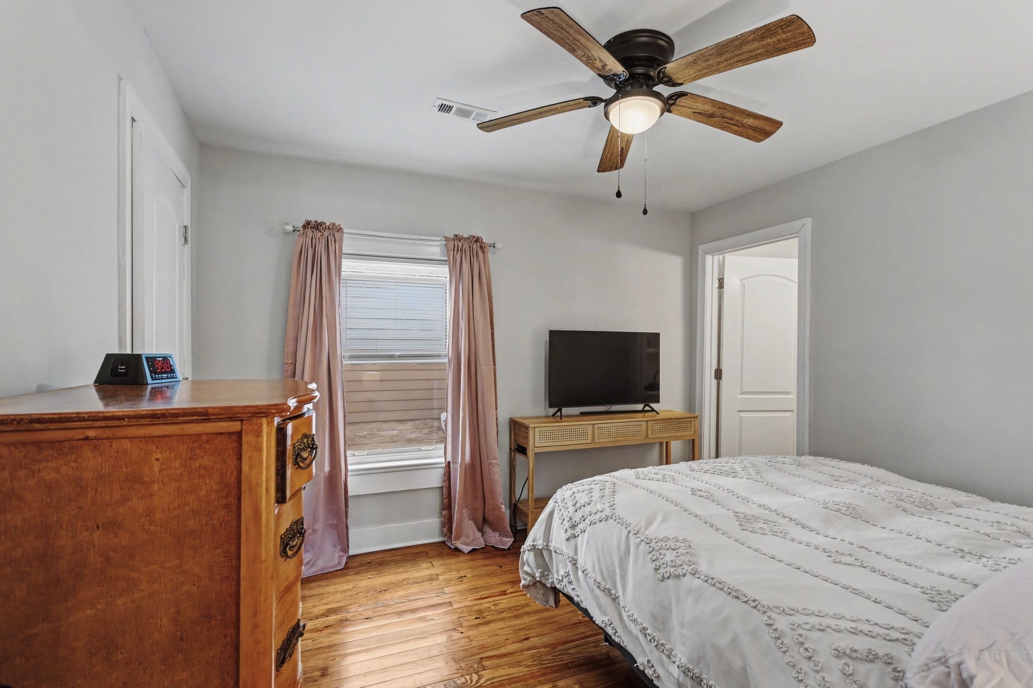 511 Florida Avenue Mount Pleasant, TN 38474 - Photo 13 of 28 a bedroom with a bed and a flat tv screen on a dresser