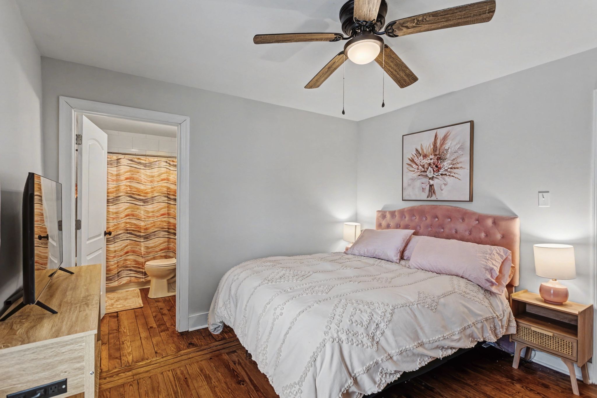 511 Florida Avenue Mount Pleasant, TN 38474 - Photo 14 of 28 a bedroom with a bed and a flat tv screen on a dresser