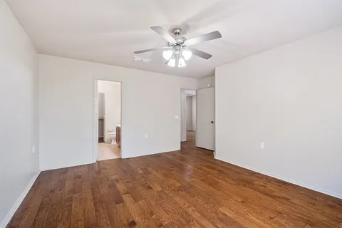 a view of an empty room and wooden floor