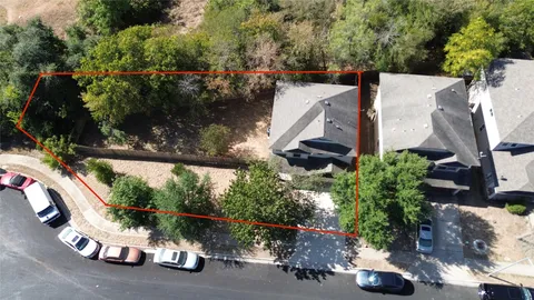 an aerial view of a house with a yard and a garage