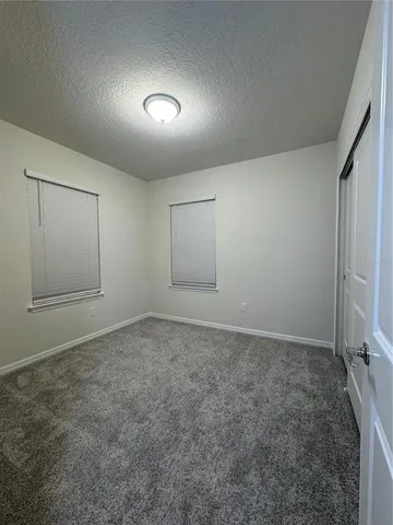 an empty room with a empty space and windows