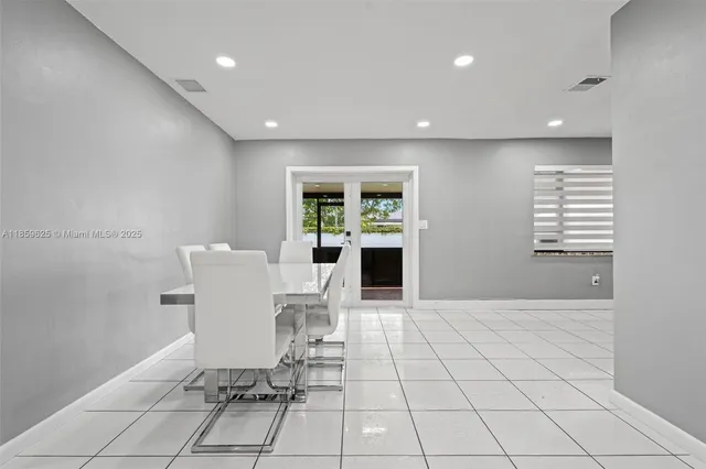 a view of a dining room with a table and chairs