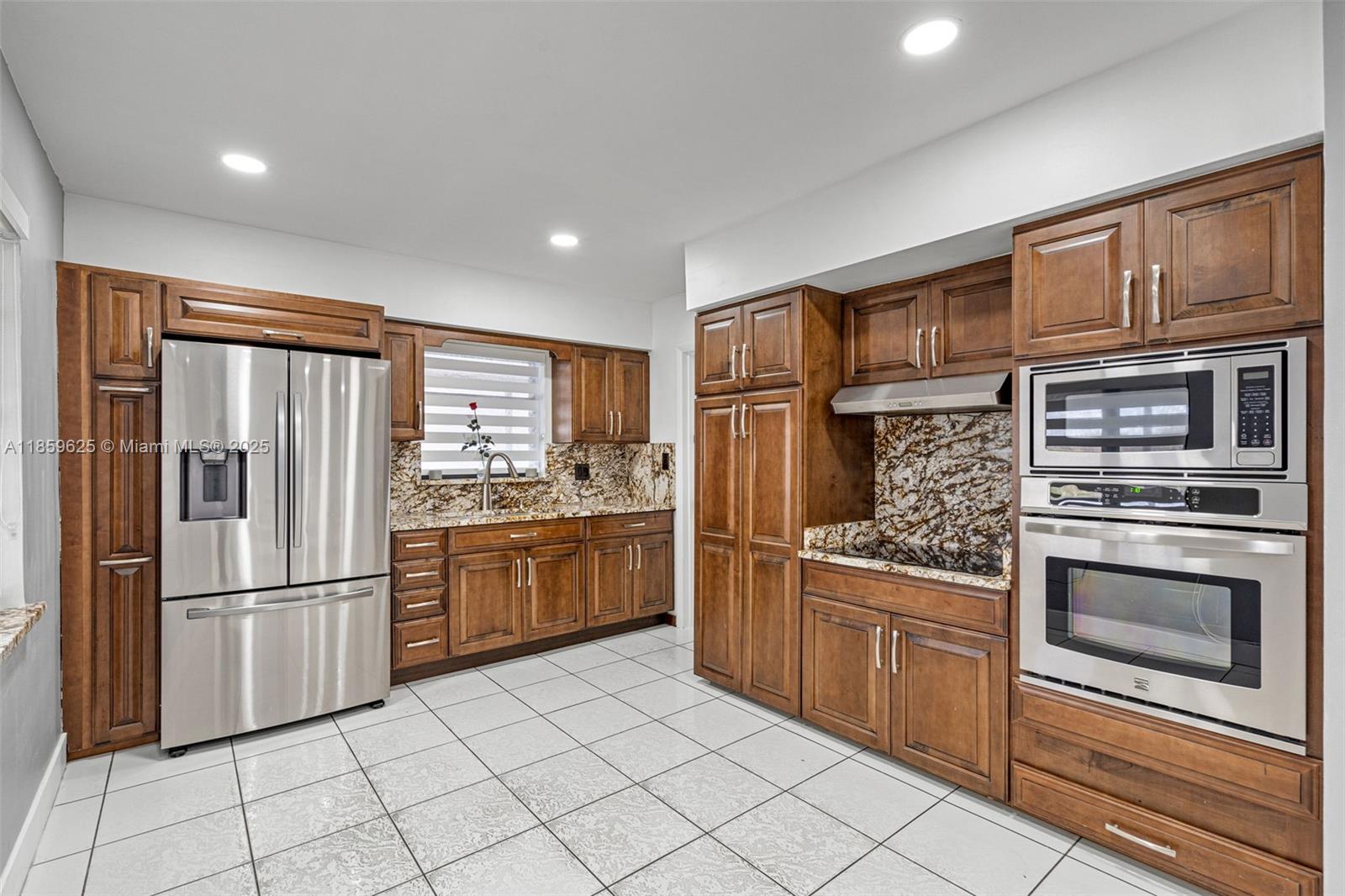 10450 Southwest 43rd Street Miami, FL 33165 - Photo 14 of 43 a kitchen with stainless steel appliances granite countertop a refrigerator sink and stove