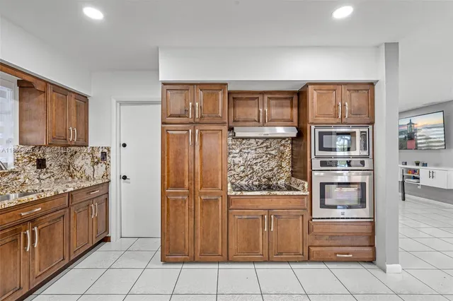 a kitchen with stainless steel appliances and cabinets