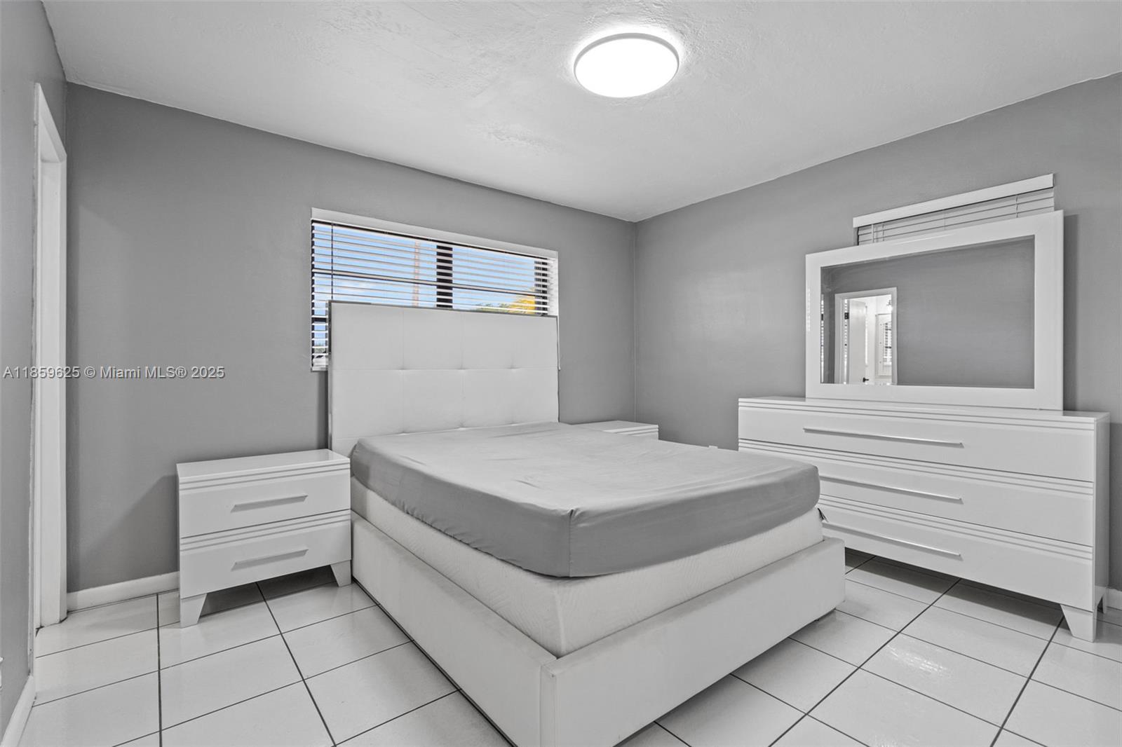 10450 Southwest 43rd Street Miami, FL 33165 - Photo 20 of 43 a bedroom with a bed and a dresser