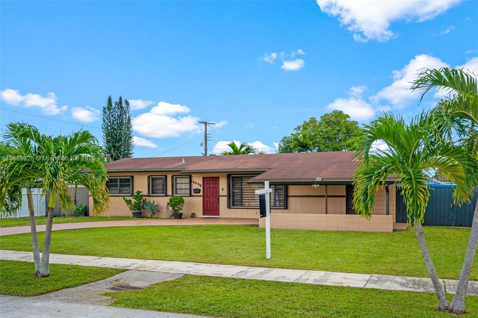 10450 Southwest 43rd Street Miami, FL 33165 - Photo 2 of 43 a view of a house with a yard