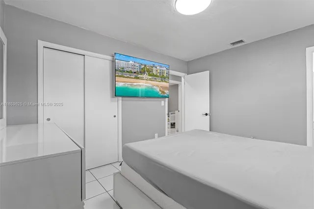 a large white bed in a white room