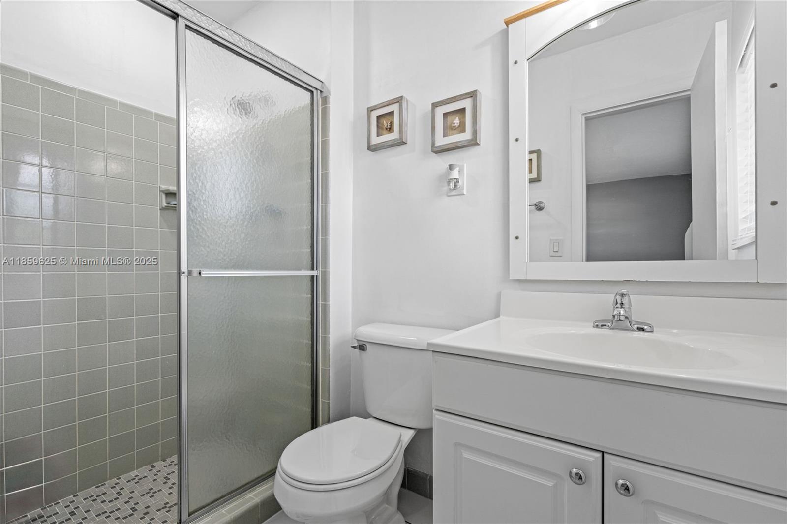 10450 Southwest 43rd Street Miami, FL 33165 - Photo 22 of 43 a bathroom with a sink a toilet and shower
