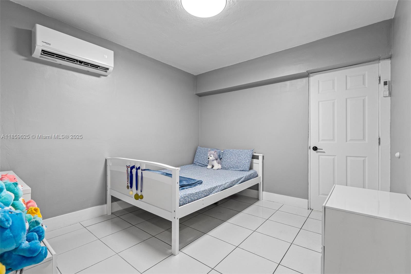 10450 Southwest 43rd Street Miami, FL 33165 - Photo 25 of 43 a room with a baby bed and a table chair