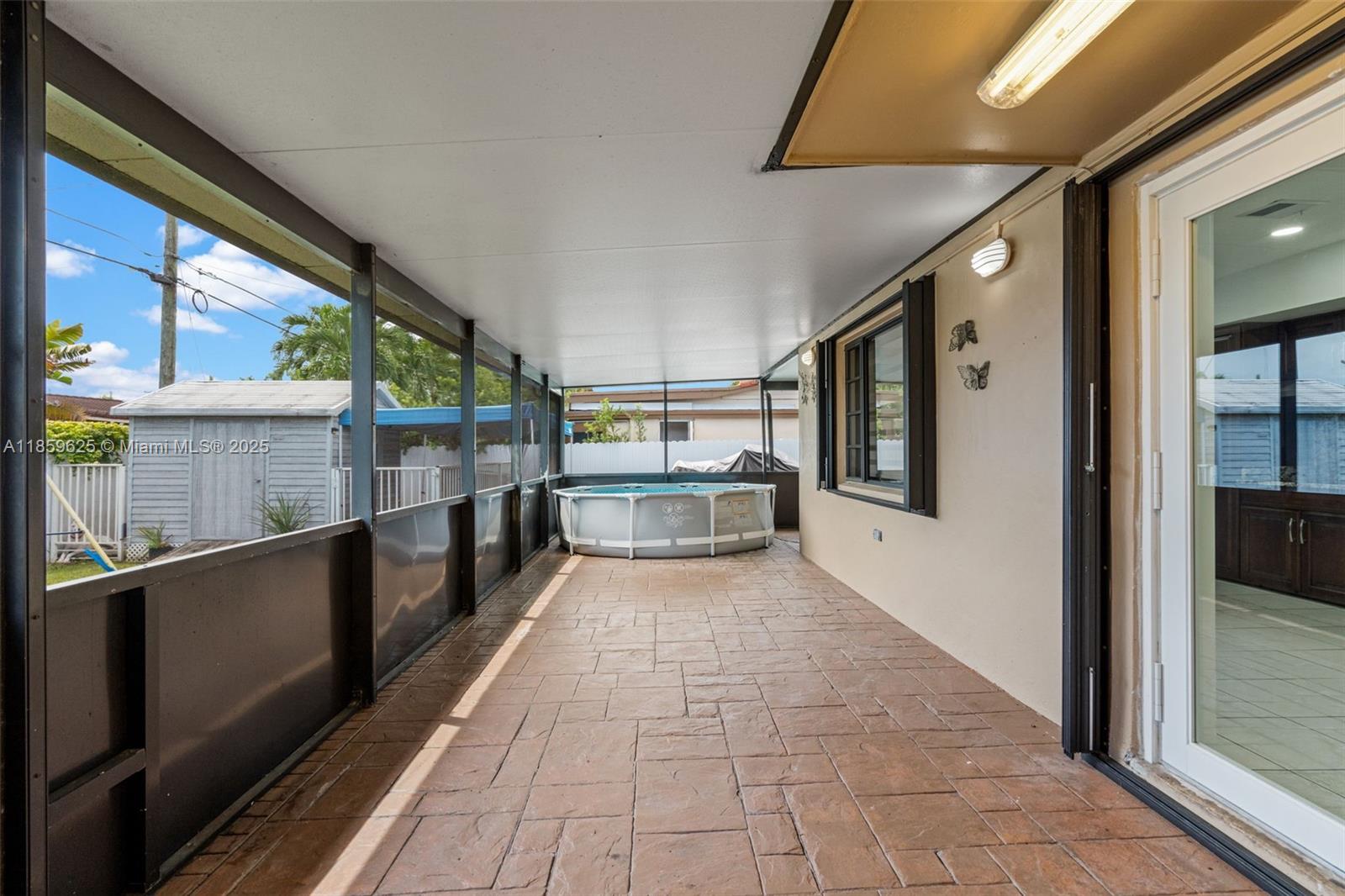 10450 Southwest 43rd Street Miami, FL 33165 - Photo 28 of 43 a view of a hallway with wooden floor and furniture