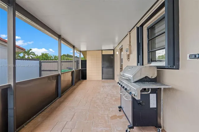 a view of a kitchen with a sink and large windows