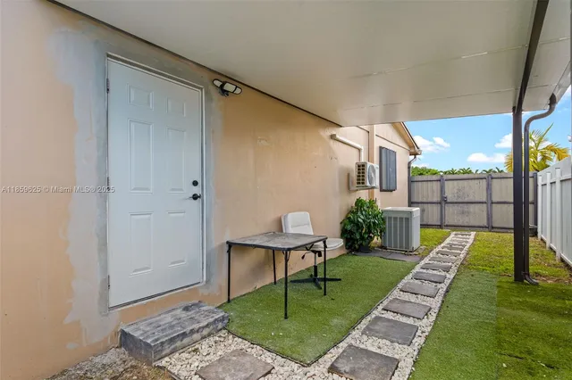 a spacious bathroom with a granite countertop sink a toilet and a mirror