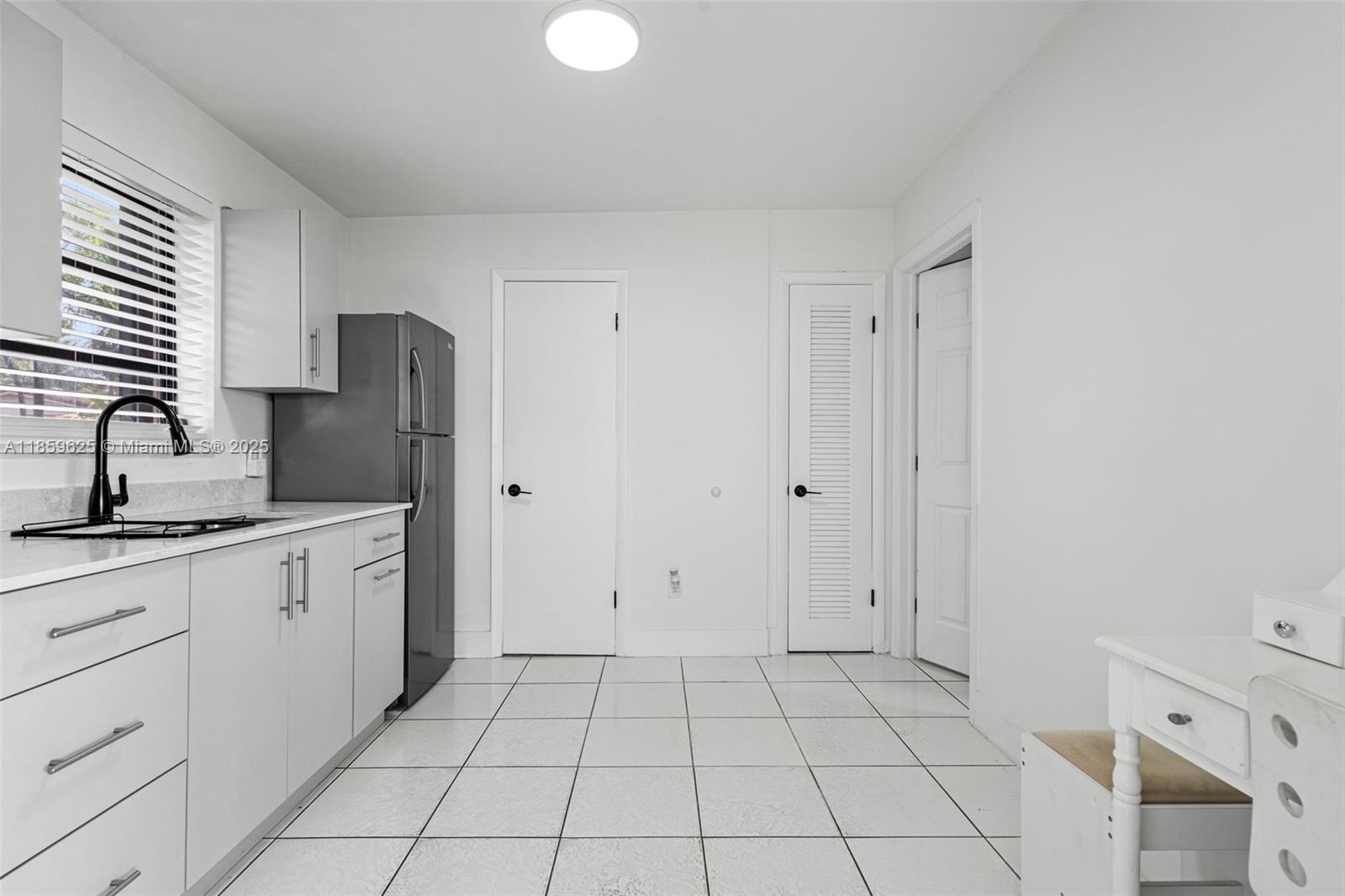 10450 Southwest 43rd Street Miami, FL 33165 - Photo 33 of 43 a spacious bathroom with a granite countertop sink a toilet and a mirror