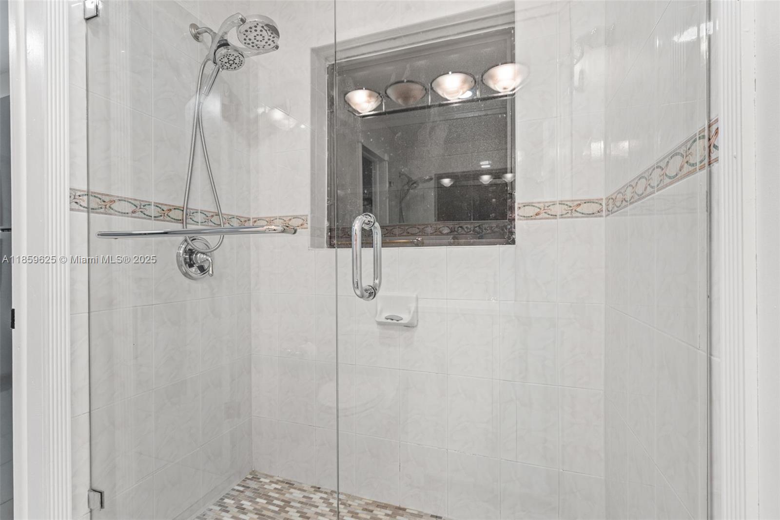 10450 Southwest 43rd Street Miami, FL 33165 - Photo 36 of 43 a bathroom with a glass shower door and a sink