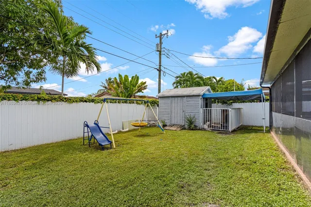 a backyard of a house with table and chairs