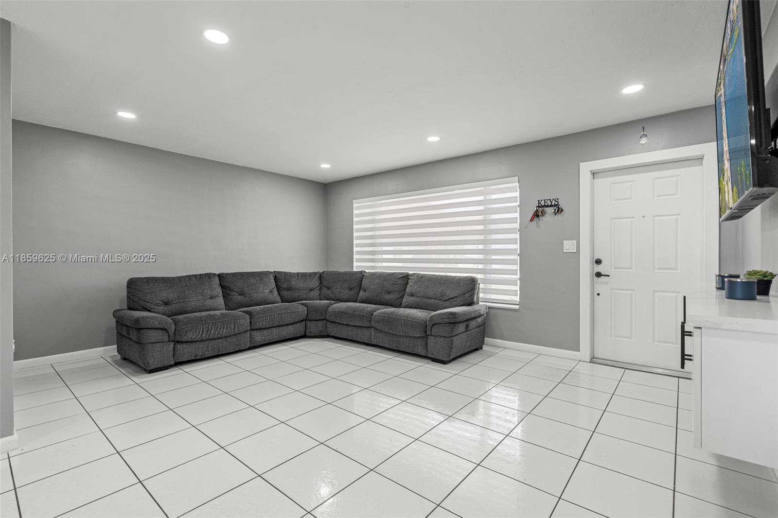 10450 Southwest 43rd Street Miami, FL 33165 - Photo 8 of 43 a living room with furniture and a flat screen tv