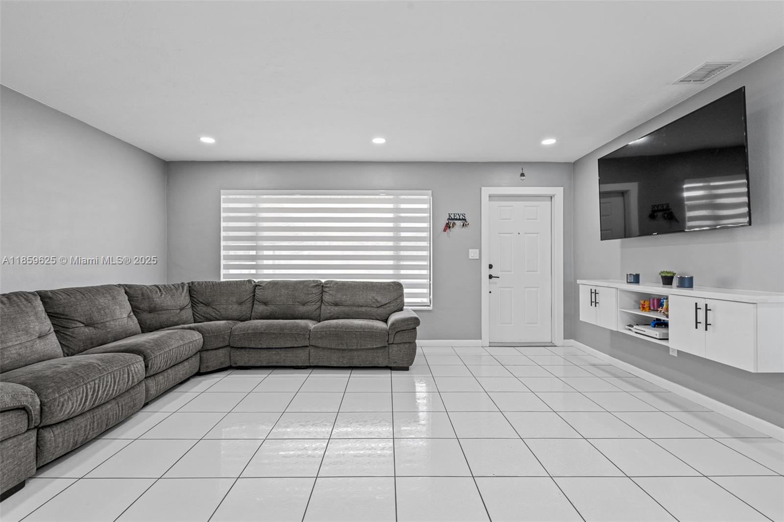 10450 Southwest 43rd Street Miami, FL 33165 - Photo 9 of 43 a living room with furniture and a flat screen tv