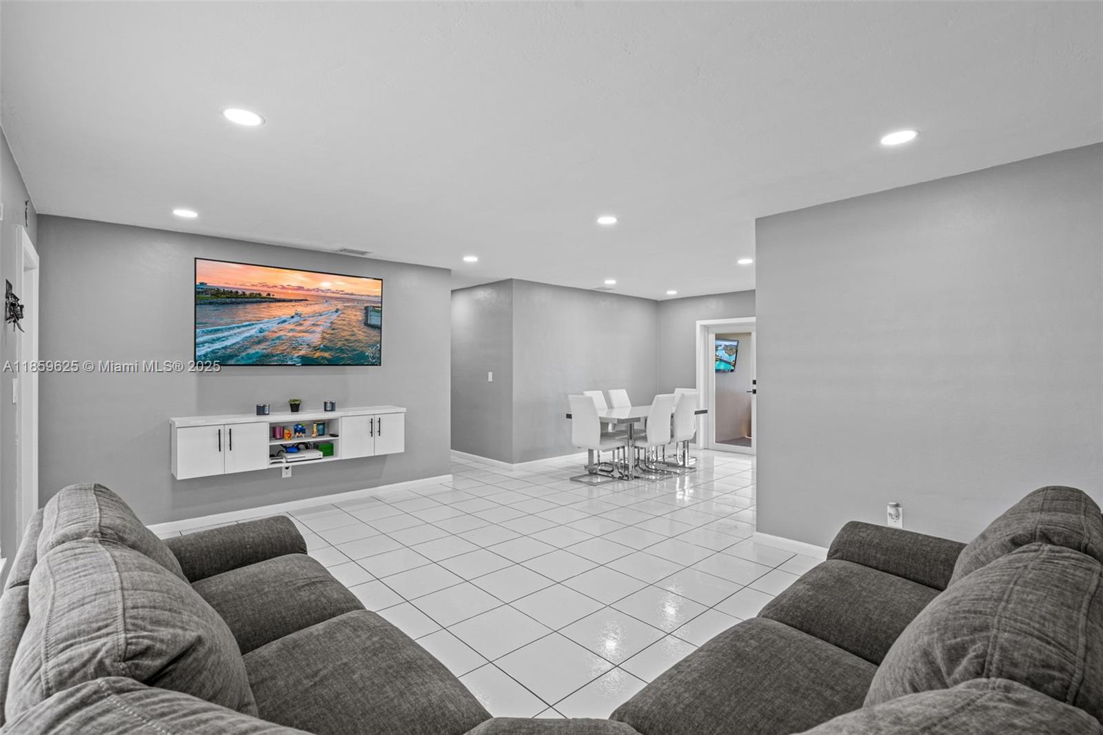 10450 Southwest 43rd Street Miami, FL 33165 - Photo 10 of 43 a living room with furniture and a flat screen tv