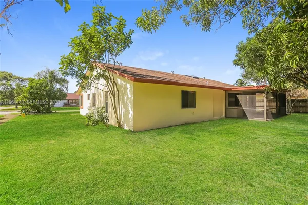 a view of a house with a backyard