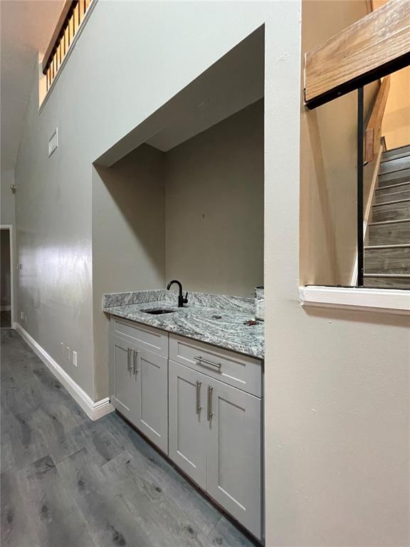 7652 Spring Bay Cove, Unit 3 Orlando, FL 32819 - Photo 11 of 30 a bathroom with a granite countertop sink and a mirror