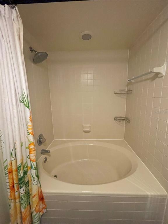 7652 Spring Bay Cove, Unit 3 Orlando, FL 32819 - Photo 17 of 30 a bathroom with a bathtub