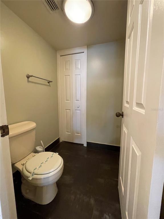 7652 Spring Bay Cove, Unit 3 Orlando, FL 32819 - Photo 18 of 30 a white toilet sitting next to a bathroom sink