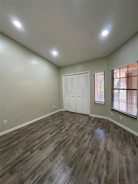 7652 Spring Bay Cove, Unit 3 Orlando, FL 32819 - Photo 19 of 30 an empty room with wooden floor and windows