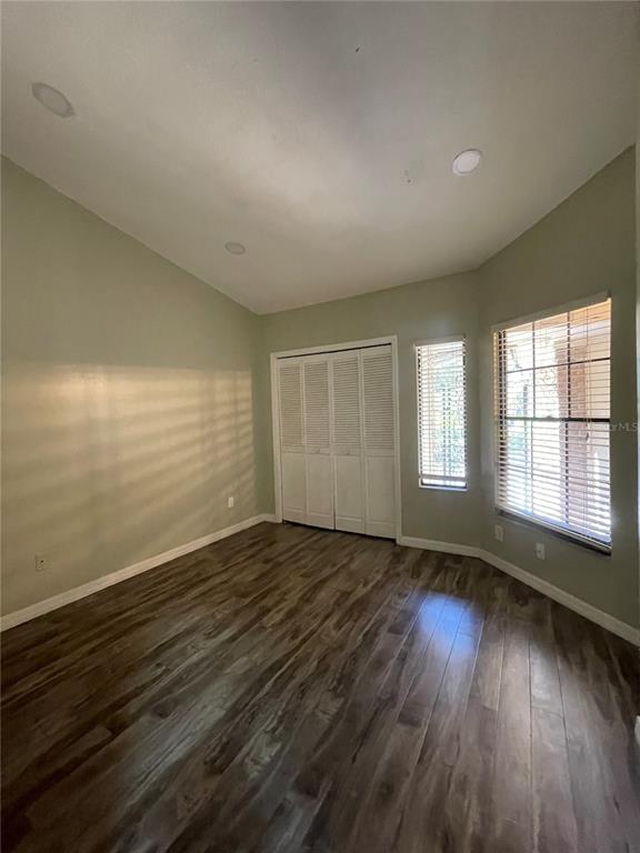 7652 Spring Bay Cove, Unit 3 Orlando, FL 32819 - Photo 20 of 30 an empty room with wooden floor and windows