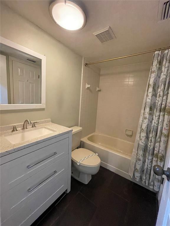 7652 Spring Bay Cove, Unit 3 Orlando, FL 32819 - Photo 22 of 30 a bathroom with a double vanity sink toilet mirror and bathtub