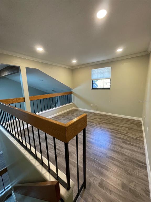 7652 Spring Bay Cove, Unit 3 Orlando, FL 32819 - Photo 23 of 30 a view of an empty room with wooden floor