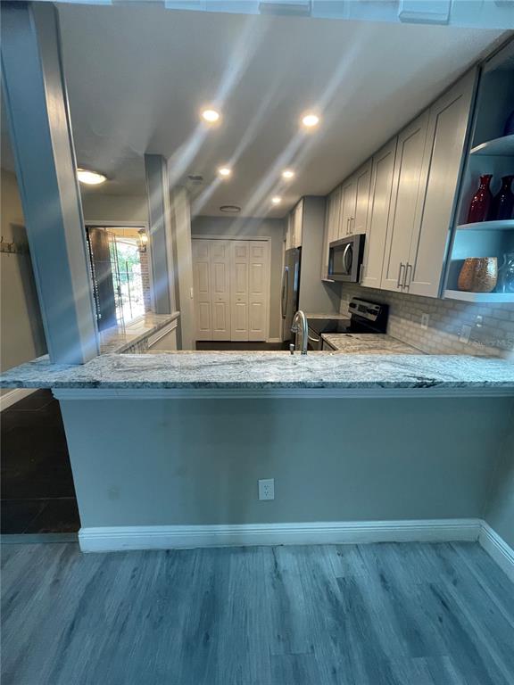 7652 Spring Bay Cove, Unit 3 Orlando, FL 32819 - Photo 6 of 30 a view of a kitchen with a sink and wooden floor